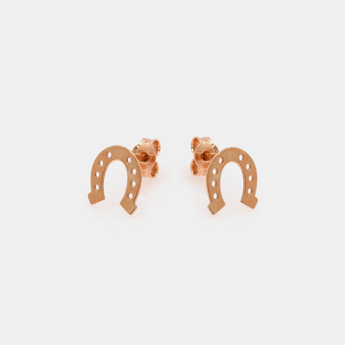 Rose gold plated silver stud earrings in the shape of a horseshoe