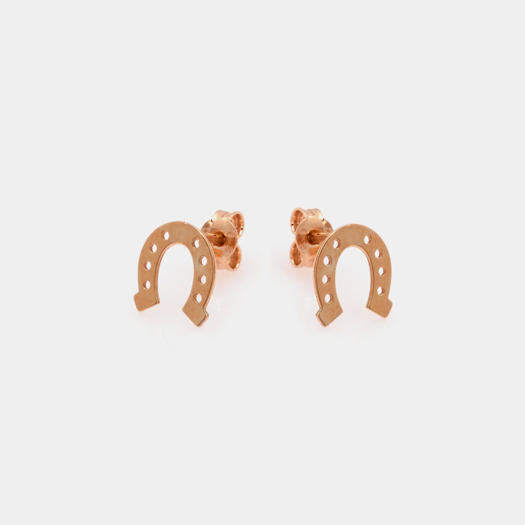 Rose gold plated silver stud earrings in the shape of a horseshoe