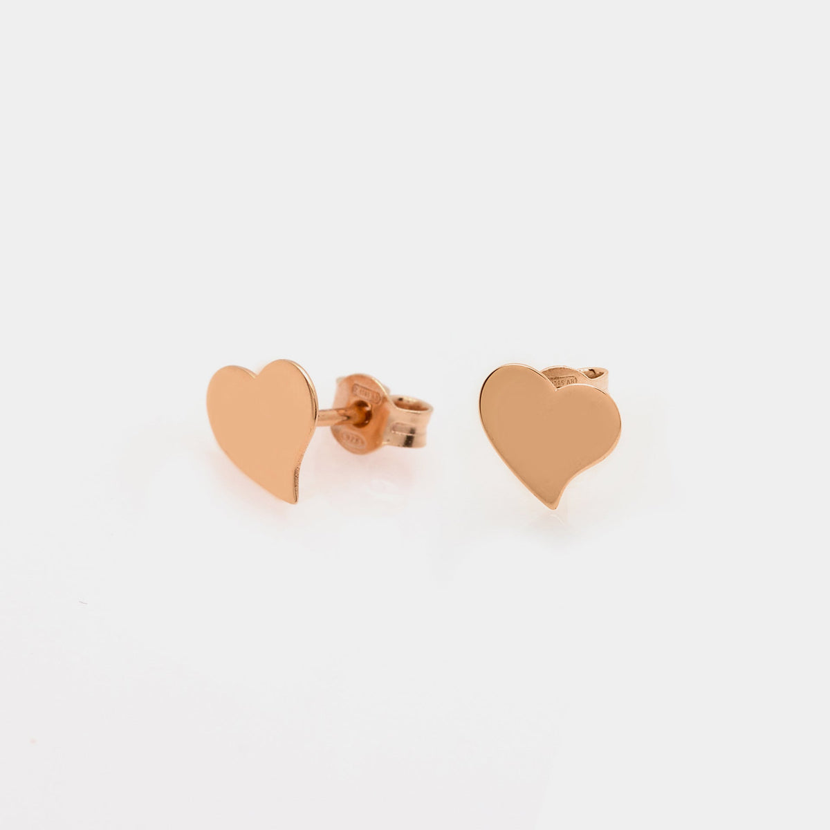 Rose gold silver stud earrings with a crooked heart