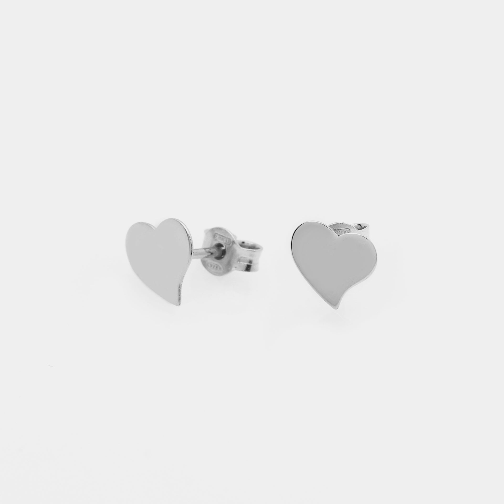 Rhodium-plated silver stud earrings in twisted heart shape