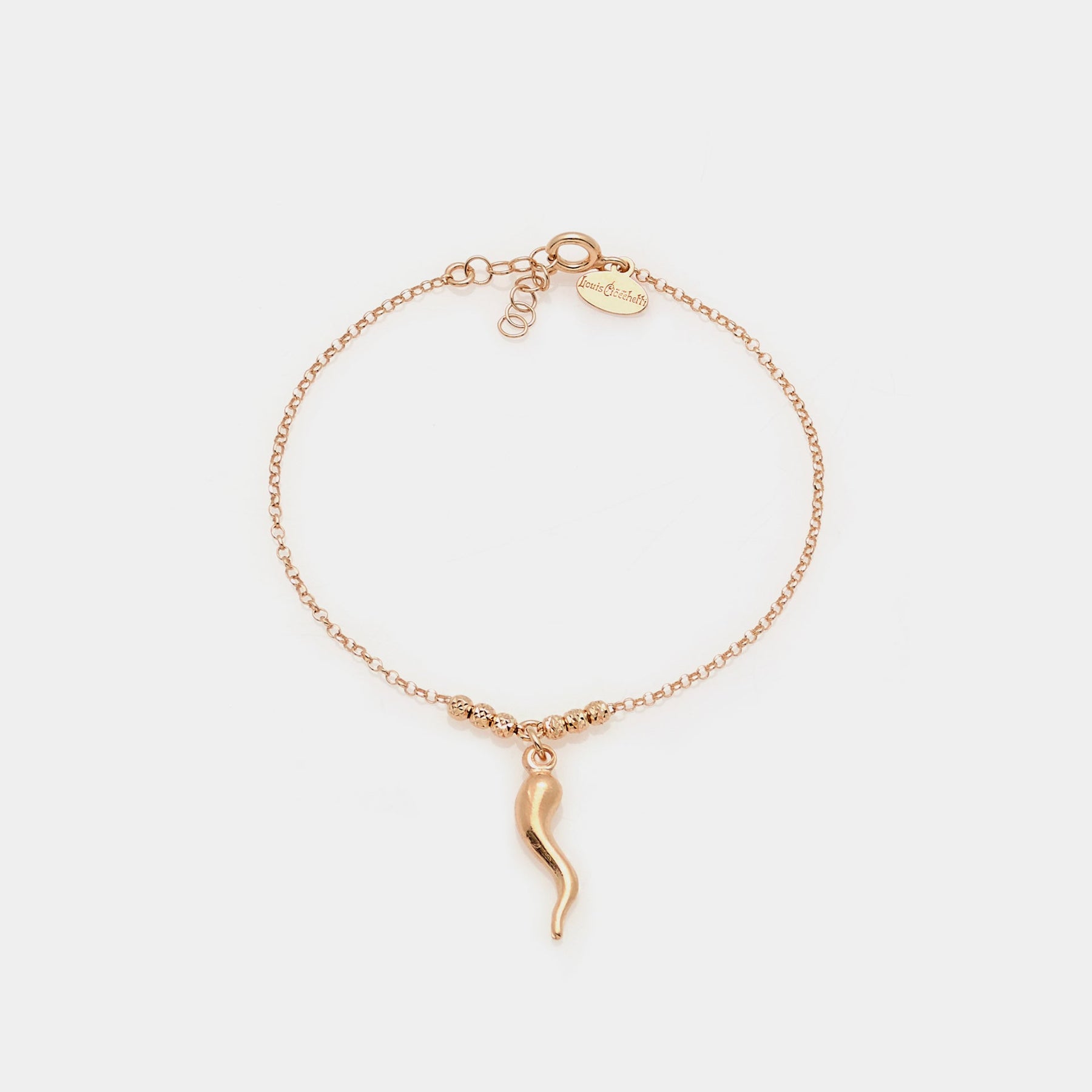 Rose gold plated silver bracelet with faceted spheres and central curved horn pendant