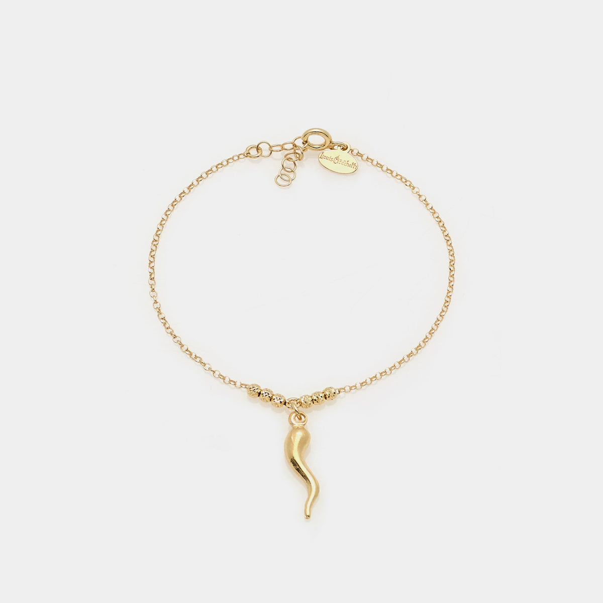 Gold-plated silver bracelet with faceted spheres and central curved horn pendant