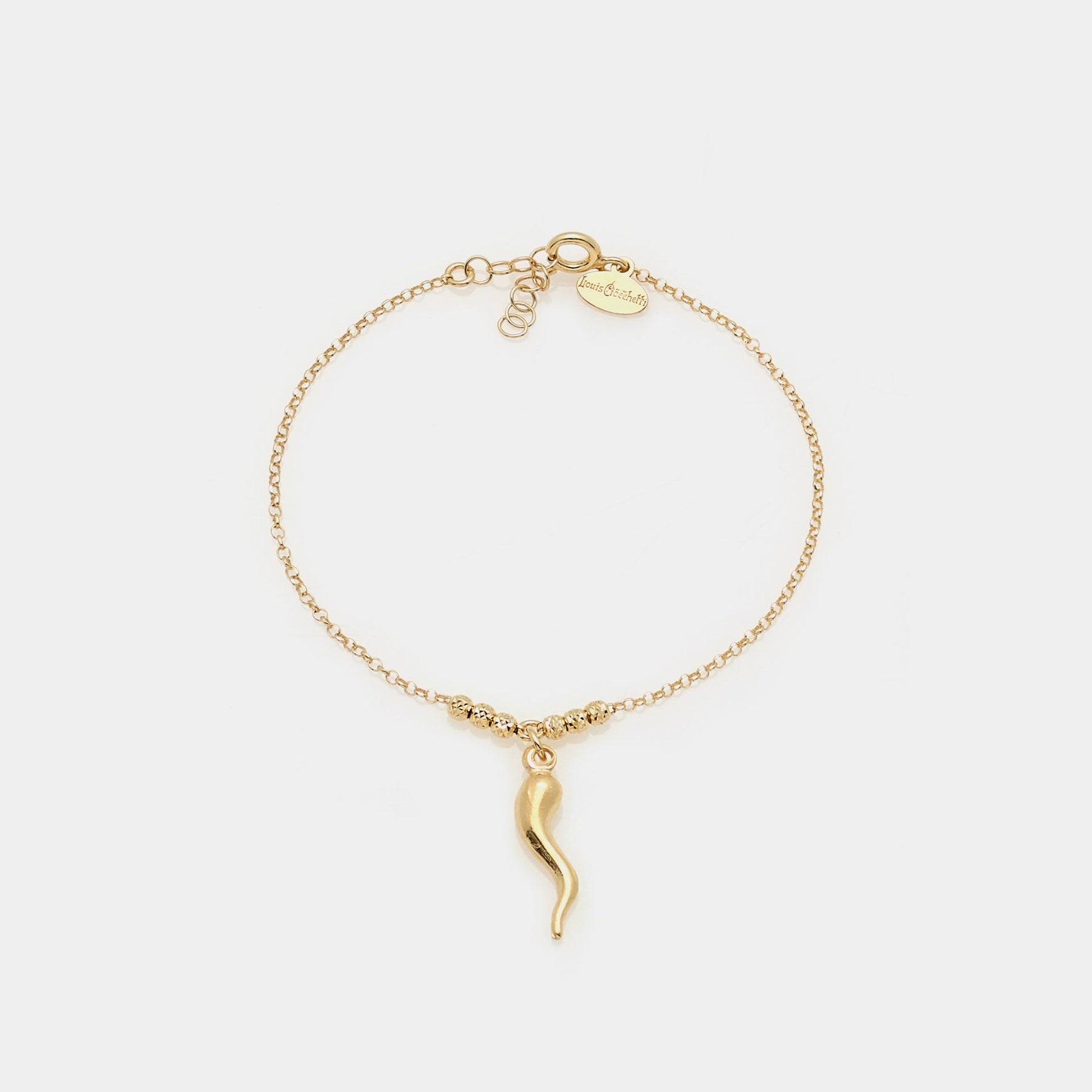 Gold-plated silver bracelet with faceted spheres and central curved horn pendant