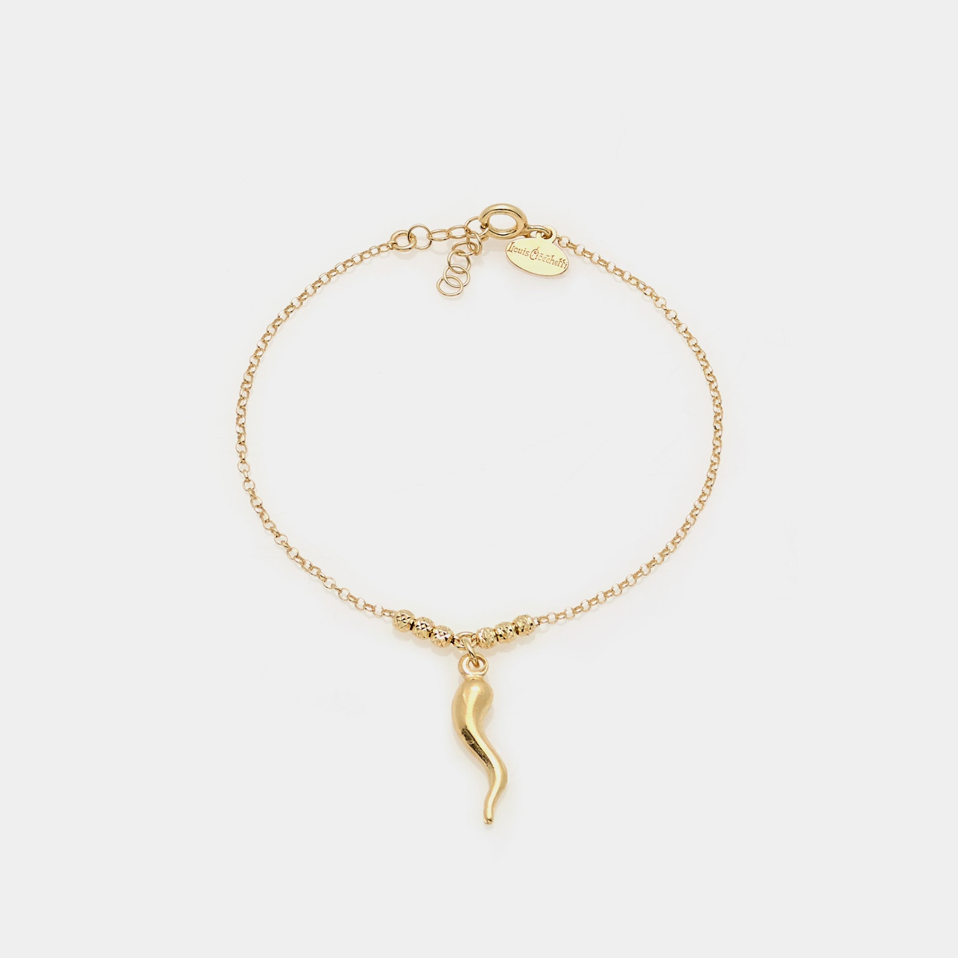 Gold-plated silver bracelet with faceted spheres and central curved horn pendant