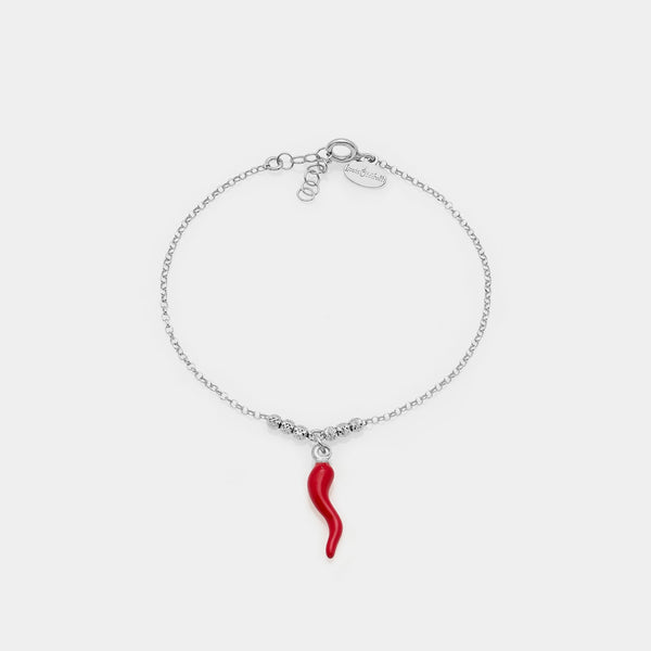 Rhodium-plated silver bracelet with faceted spheres and central hanging red enameled horn