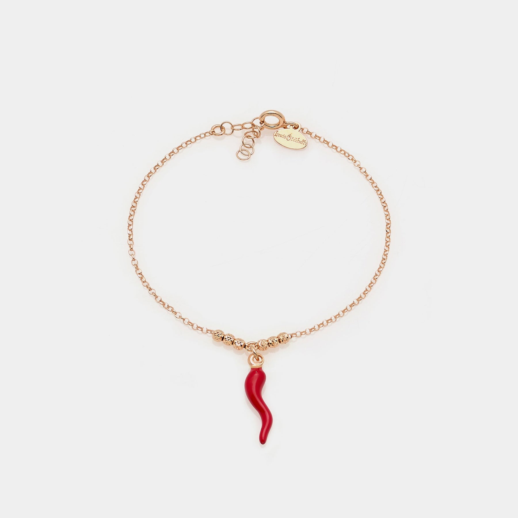 Rose gold plated silver bracelet with faceted spheres and central hanging red enameled horn