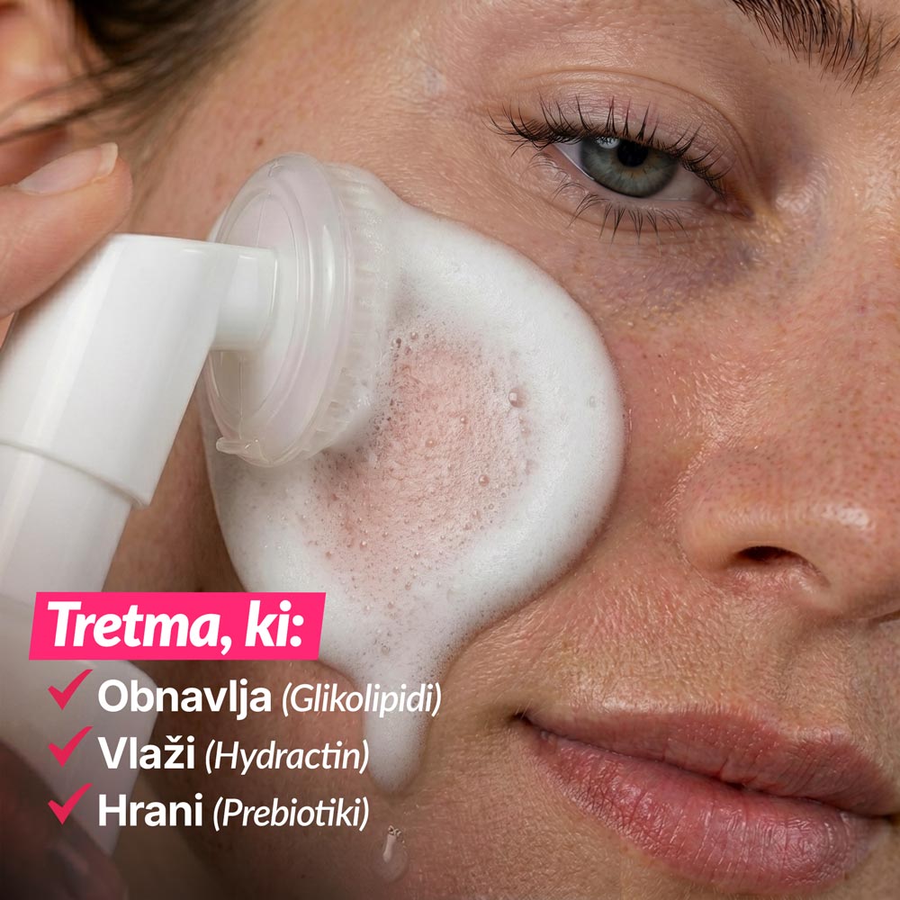 Close-up of a woman using a cleansing device with foamy facial cleanser; promotes skin renewal, hydration, and nourishment.