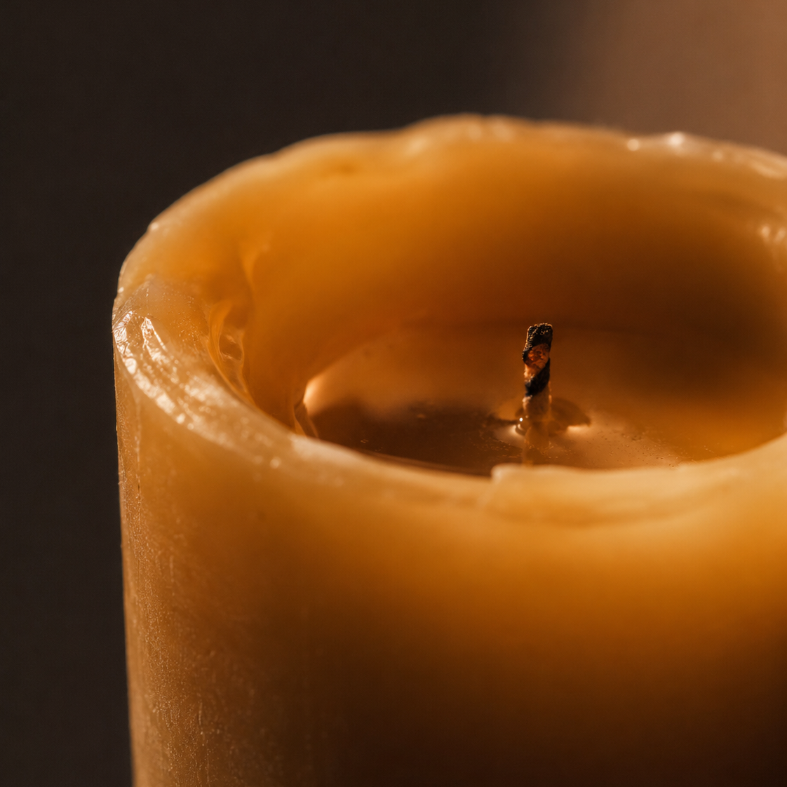 Close-up of a CocoBee beeswax pillar candle