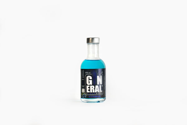 Clear glass gin bottle with bright blue liquid and a metal cap, standing on a white background edge-to-edge label visible.