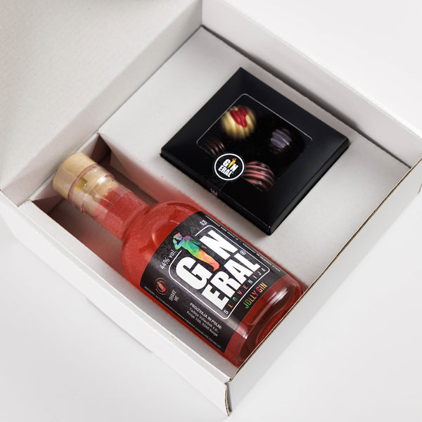 White gift box opened to reveal a bottle of red gin and a small black box of chocolates tucked beside it on the white interior surface, suggesting a gift set.