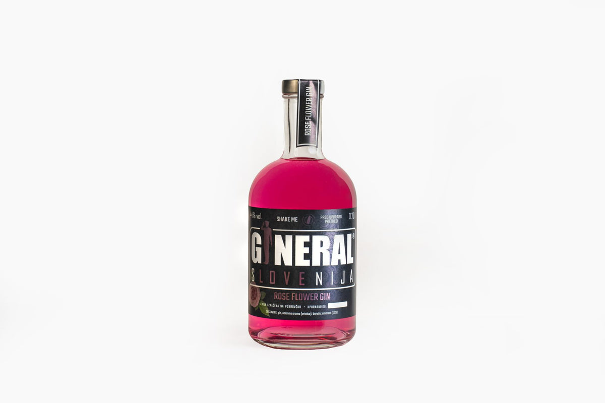 Pink gin bottle with black label reading Rose Flower Gin, centered on a white backdrop.