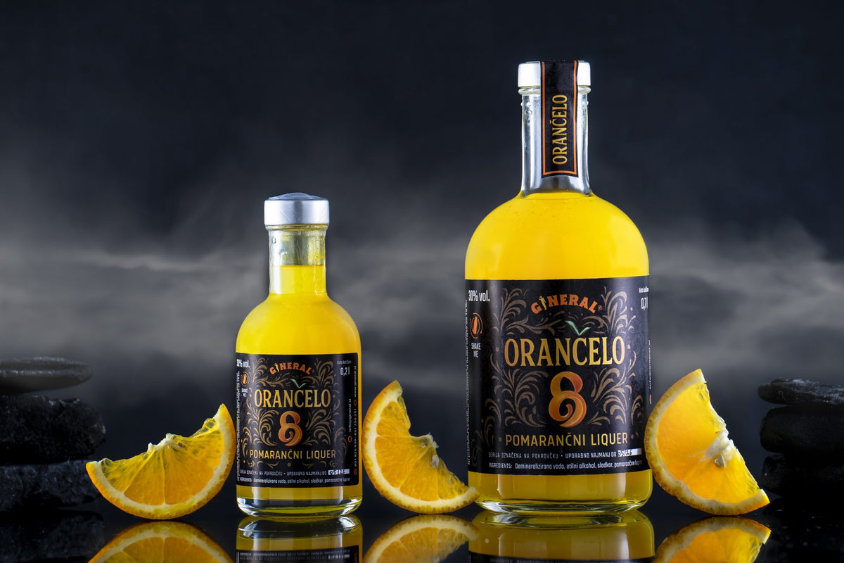 Two yellow-orange bottles of orange liqueur stand on a glossy surface, surrounded by orange wedges against a dark, smoky background.