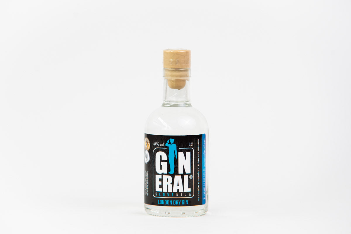 Small clear glass bottle of London Dry Gin with a tan cork stopper, placed on a white background.