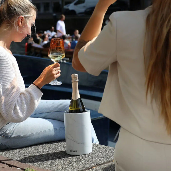Coolenator white marble design wine cooler with a bottle of wine two girls canals of asterdam drinking wine in the sun